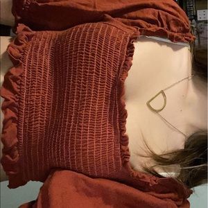 very cropped orangeish shirt.